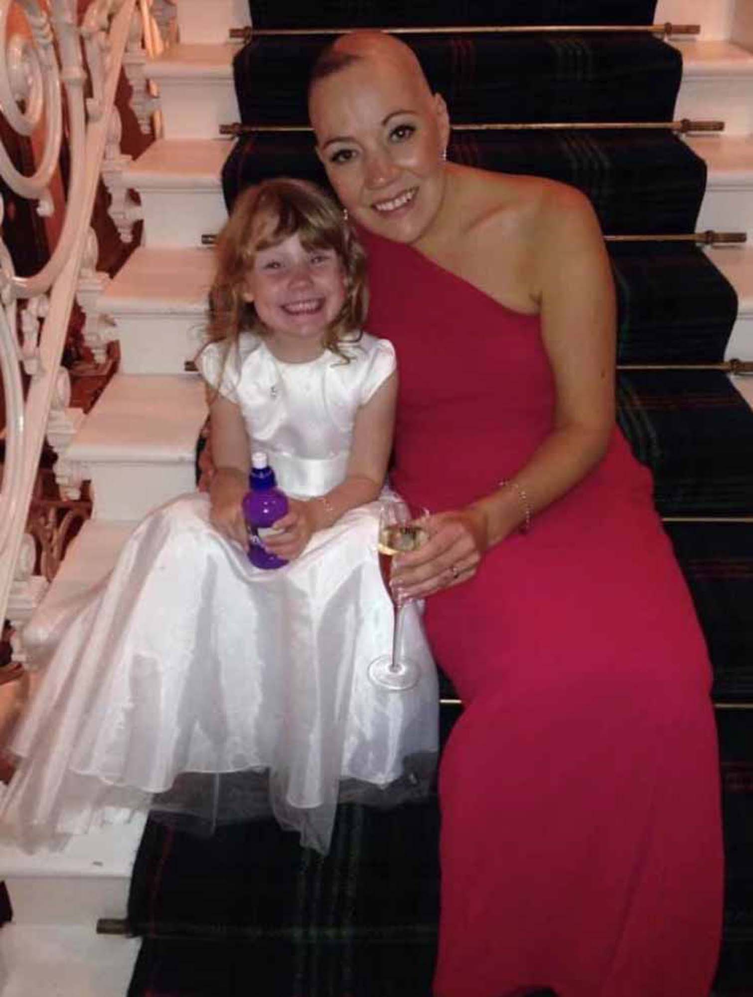 Suzanne and her daughter smile together for a picture at a family celebration