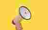 Holding a megaphone on a yellow background